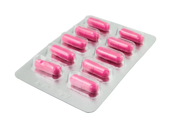Pílulas rosa embalar em branco — Fotografia de Stock