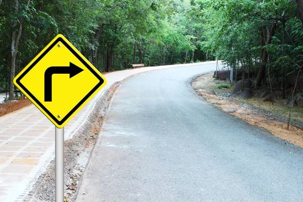 Turn right warning sign on curve road — Stock Photo, Image