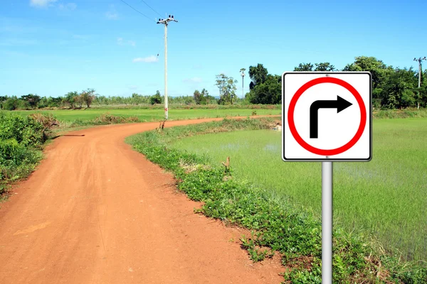 Turn right sign with soil road — Stock Photo, Image