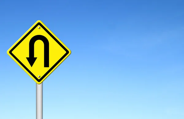 Yellow warning sign u-turn roadsign with blue sky background — Stock Photo, Image
