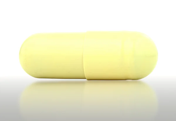 Close-up of yellow medical capsule — Stock Photo, Image