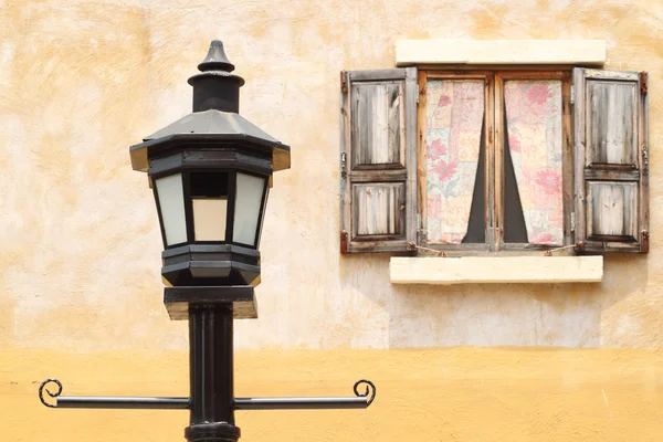 Ancient lamppost with vintage window — Stock Photo, Image