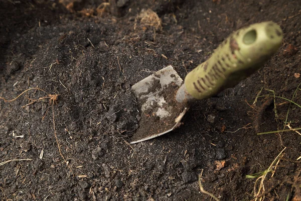 Small shovel stuck in soil — Stock Photo, Image