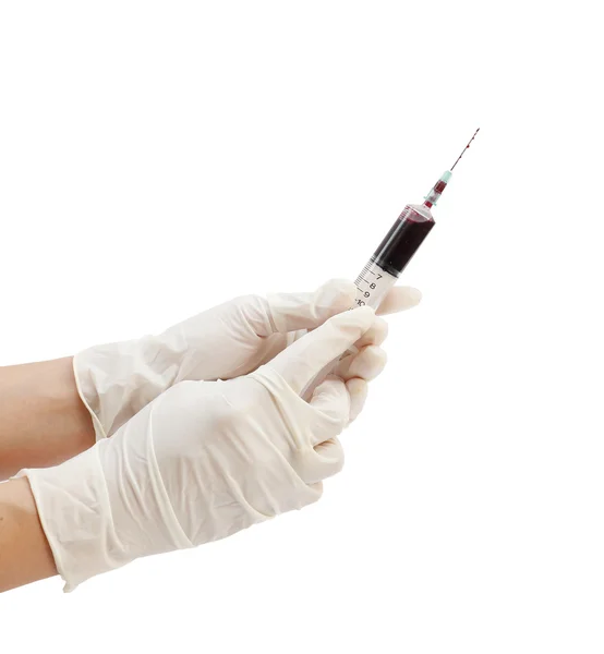 Syringe with blood in hand on white Stock Picture
