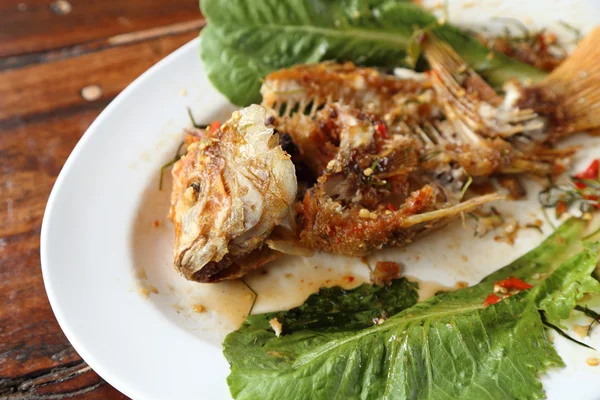 Makan ikan rubi goreng diatapi dengan saus manis, sauer dan saus pedas — Stok Foto
