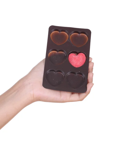 Mani che tengono caramelle cuore — Foto Stock