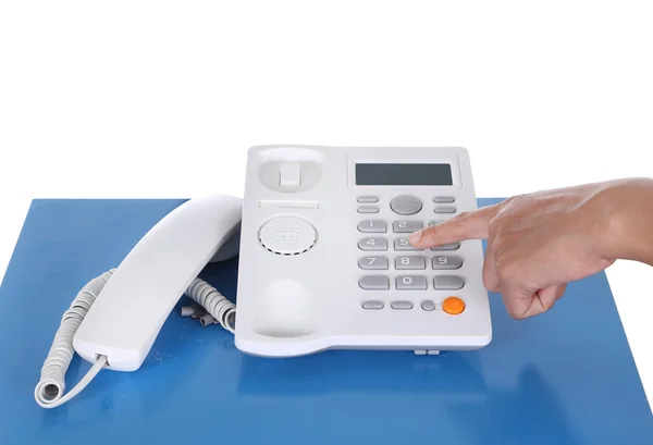 Hand with telephone on a table — Stock Photo, Image