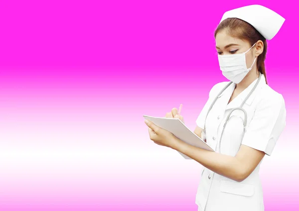 Asian female nurse writing medical report — Stock Photo, Image