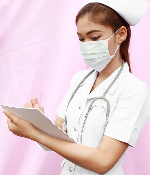 Female nurse writing medical report — Stock Photo, Image