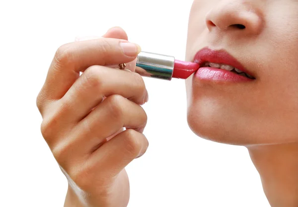 Beautiful woman is applying her lips with pink lipstick — Stock Photo, Image