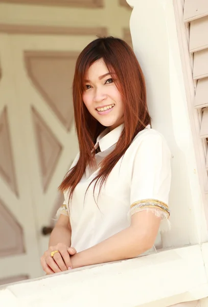 Woman smiles in traditional wood house — Stock Photo, Image