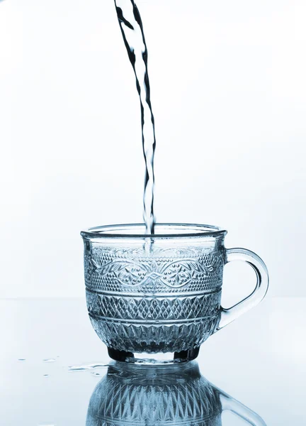 Cup glass with water pouring — Stock Photo, Image