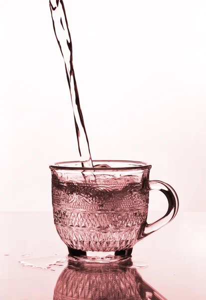 Cup glass with water pouring — Stock Photo, Image