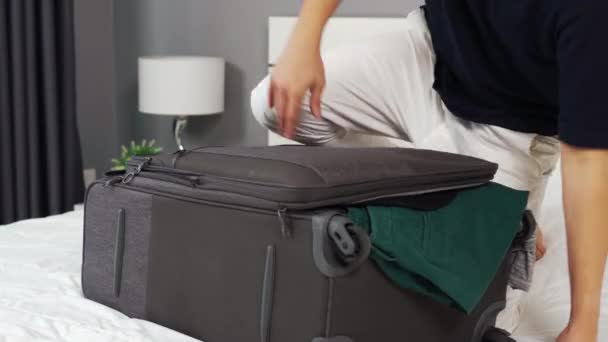 Man Probeert Sluiten Overvolle Koffer Haar Bed — Stockvideo