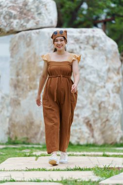 Parkta yürüyen mutlu hamile kadın