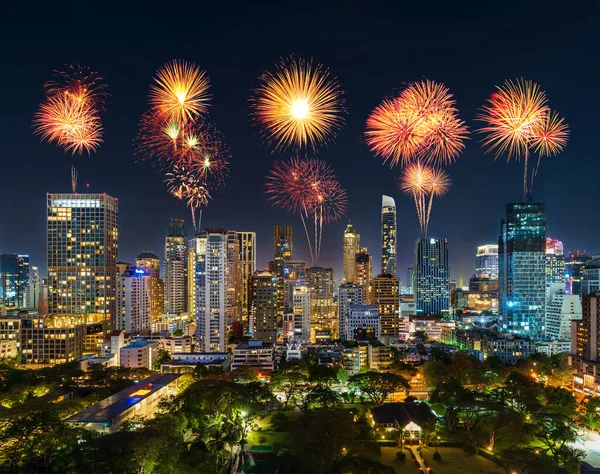 happy new year fireworks over buildings cityscape near Witthayu road at night in Bangkok city, Thailand