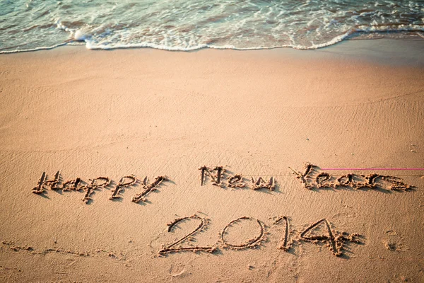 Escrevendo Feliz Ano Novo 2014 na praia na Tailândia — Fotografia de Stock