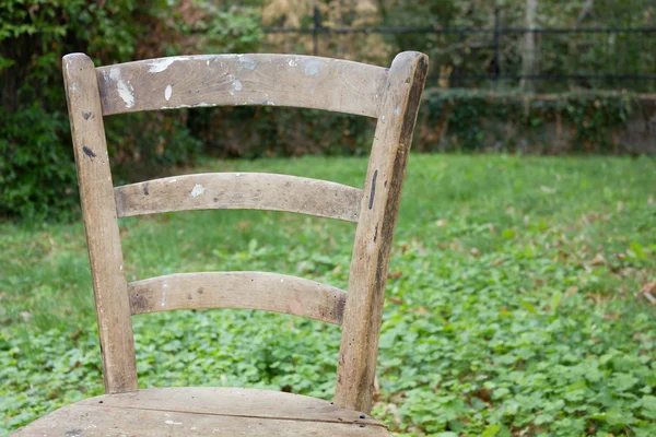 Closeup on a Chair Back Against a Grassy Background