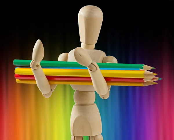 Wooden Mannequin Carrying Colored Pencils — Stock Photo, Image