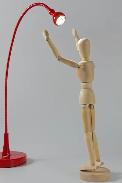 Wooden Mannequin Under the Beam of a Lamp — Stock Photo, Image