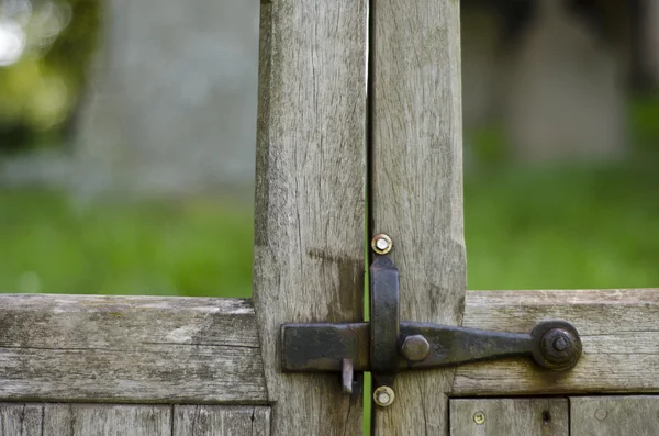 Iron latch on wooden handcrafted gate. — Stock Photo, Image