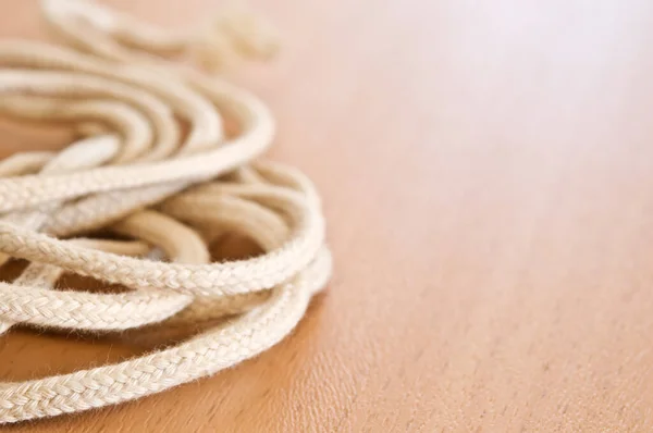 Tangled string on wooden table.