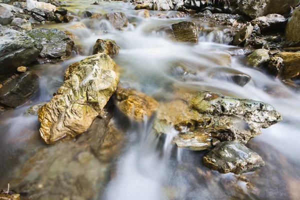 Pebbles or rocks in creek or stream flowing water — Stock Photo, Image