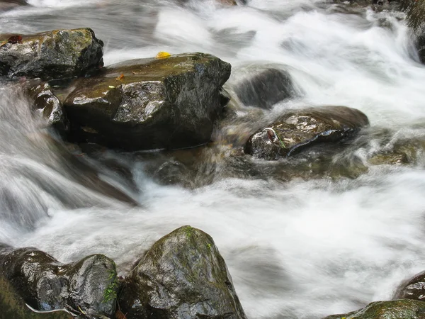 Pebbles or rocks in creek or stream flowing water — Stock Photo, Image