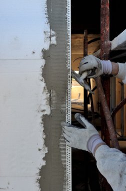 Construction site - Installing external insulation. clipart