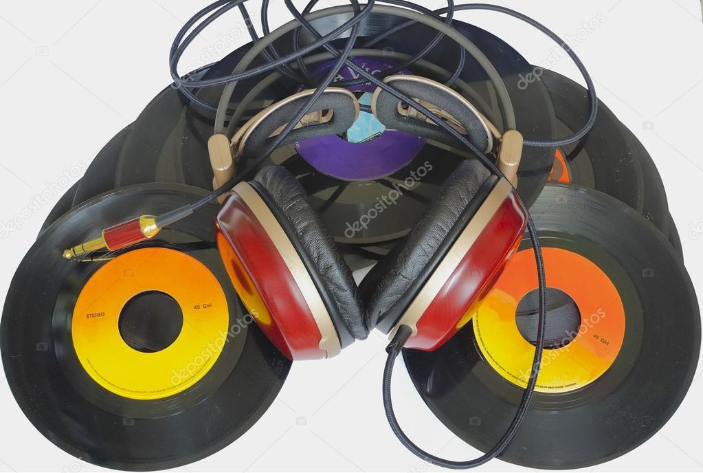 Headphones arranged over some old 45 rpm records