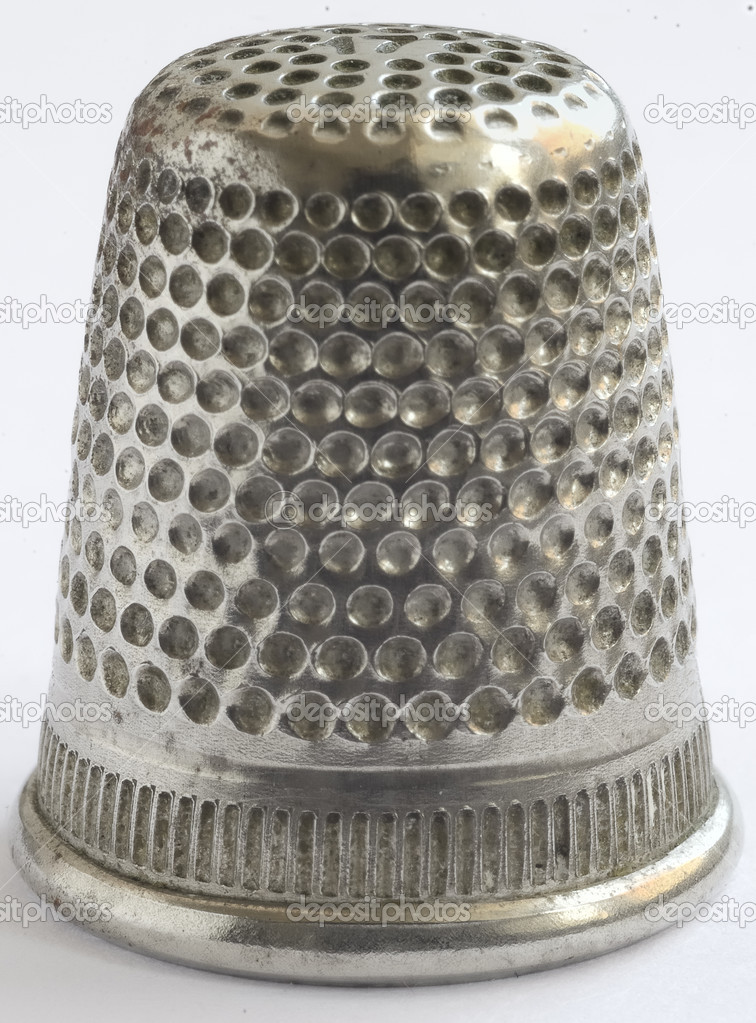 Close up a very old thimble, white background.