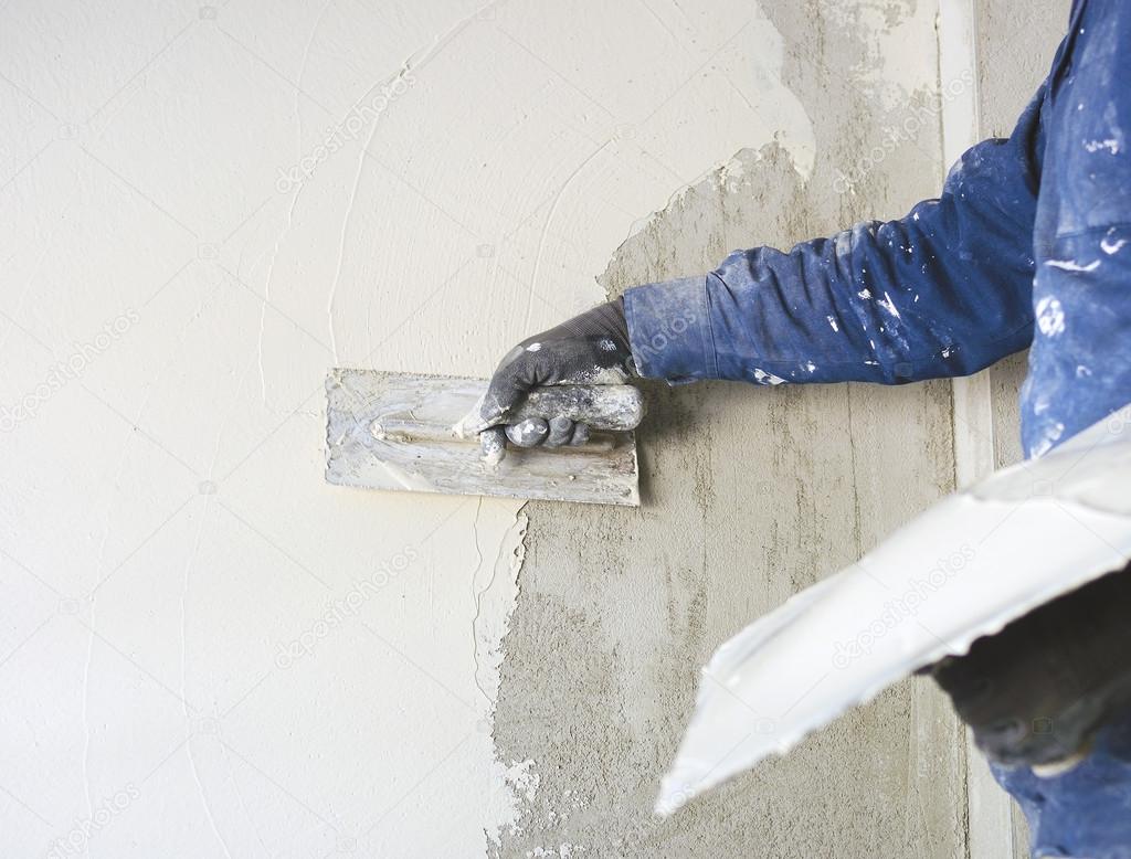 Worker plastering tool plaster marble on interior plaster rough