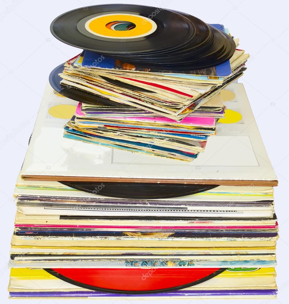 33 and 45 rpm vinyl discs stack on white background