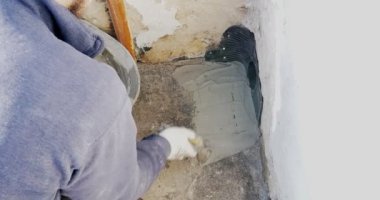 İşçi düz bir terastan yağmur suyu boşaltmak için hızlı ayarlanmış havan topu ile bir PVC kol yerleştirir.