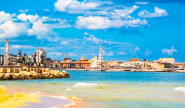 Bari, Italy - February 9, 2022: view of Bari's waterfront with tourists strolling. In the background the cathedral and the Margherita theater. Orton effect
