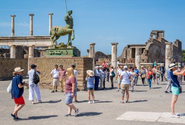 Pompeii, Italy - 3 June 2018: Tourists visiting the excavations of Pompeii. Many stop to take selfies