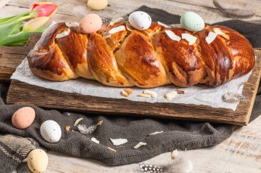 Portekiz geleneksel paskalya pastası. Paskalya masasında yumurtalı folar. Çiçekli laleler, renkli boyanmış yumurtalar ve tüyler.