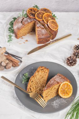 Noel portakalı ve baharatlı kek. Mutfak tezgahında kurutulmuş portakallarla süslenmiş.