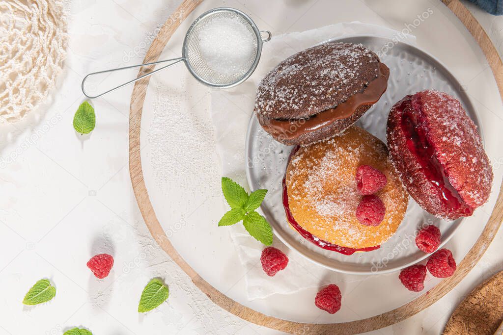 Bolas de Berlim, or Berlin Balls. Portuguese fried dough with sugar, Filled with chocolate or raspberry jam. Portuguese fried dough with sugar. Portuguese fried dough with sugar