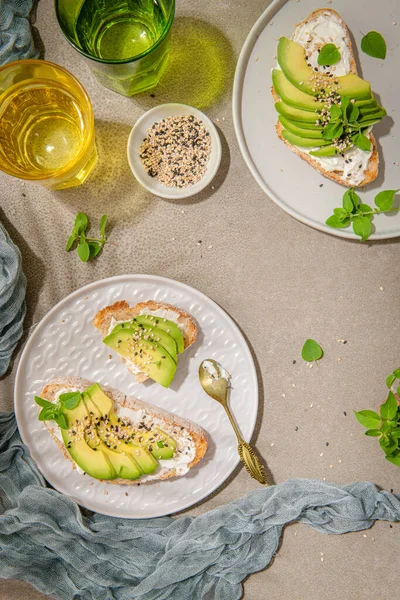 Healthy toast with avocado cream cheese and wheat bread on a plate. Delicious snacks and avocado sandwiches. Food composition, tasty Italian meal.