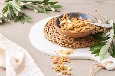 Healthy cereal breakfast. Mixed muesli cereals in a ceramic bowl in kitchen countertop. For healthy food and diet concepts. Top view