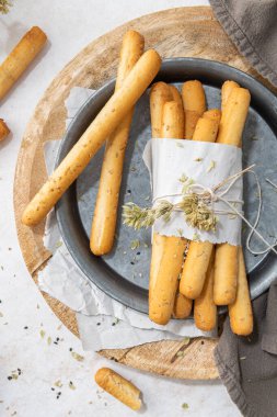 Breadsticks grissini. Bread sticks with sesame seeds, oregano and olive oil and balsamic vinegar on kitchen countertop. Top view. Flat lay with copy space