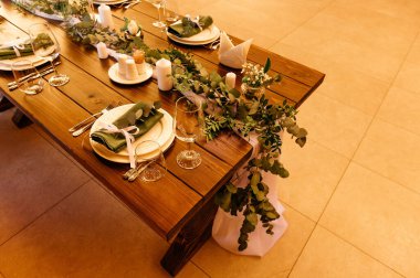 Masa örtüsü olmayan ahşap bir masa taze çiçeklerle servis edilir ve dekore edilir. Açık Cafe.