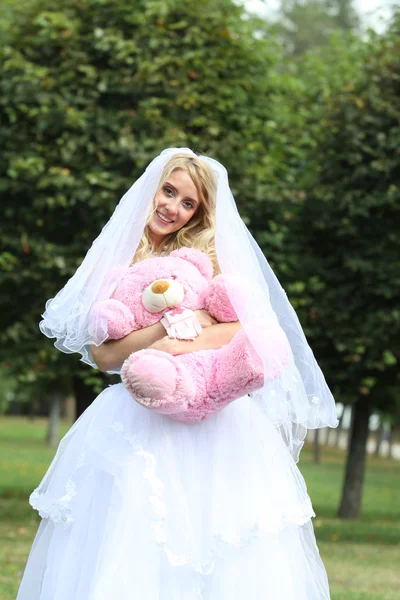 Happy bride with toy — Stock Photo, Image