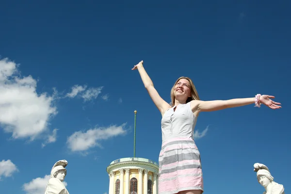 Happy blonde woman with arms raised — Stock Photo, Image