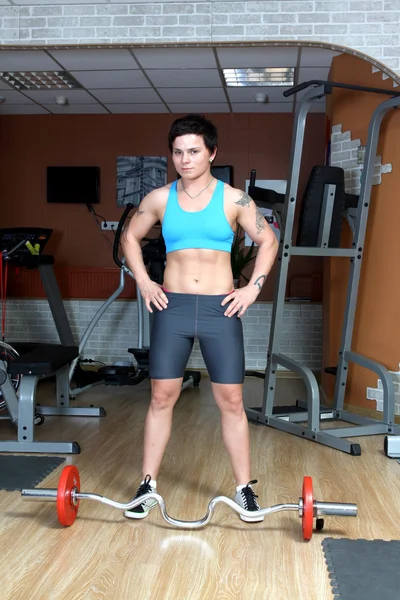 Strong young brunette woman in gym — Stock Photo, Image