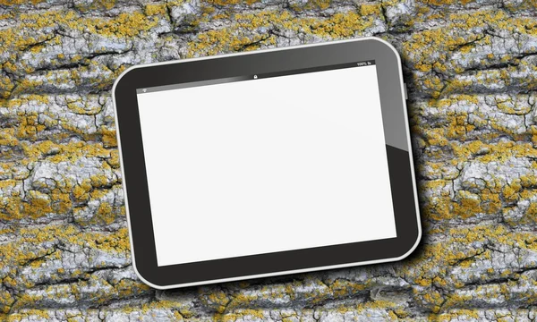 Tablet pc on tree bark with green moss — Stock Photo, Image