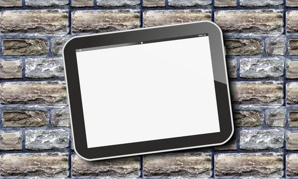 Tablet pc on grunge bricks — Stock Photo, Image