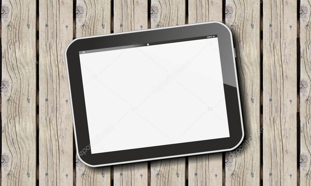 Tablet pc on wooden fence