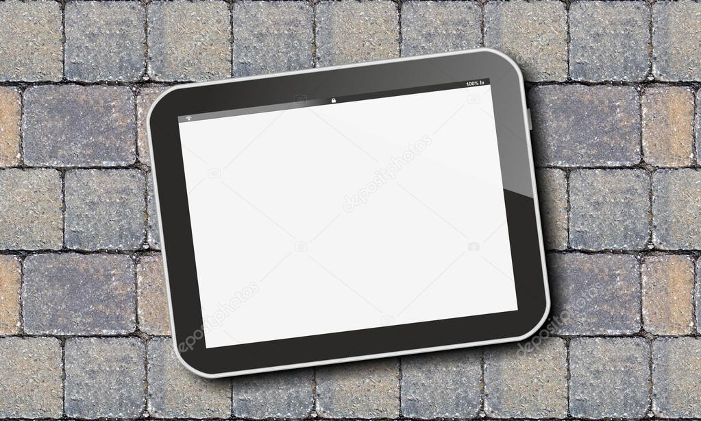 Tablet pc on paving stones